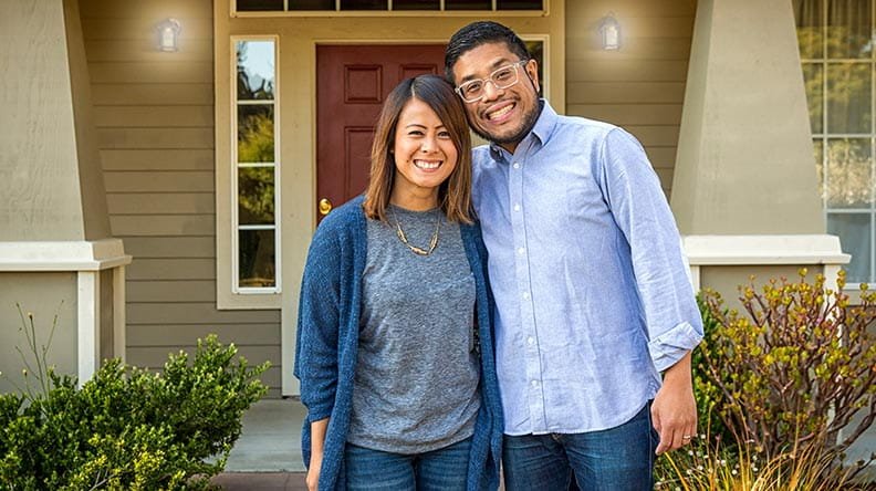 couple in front of house