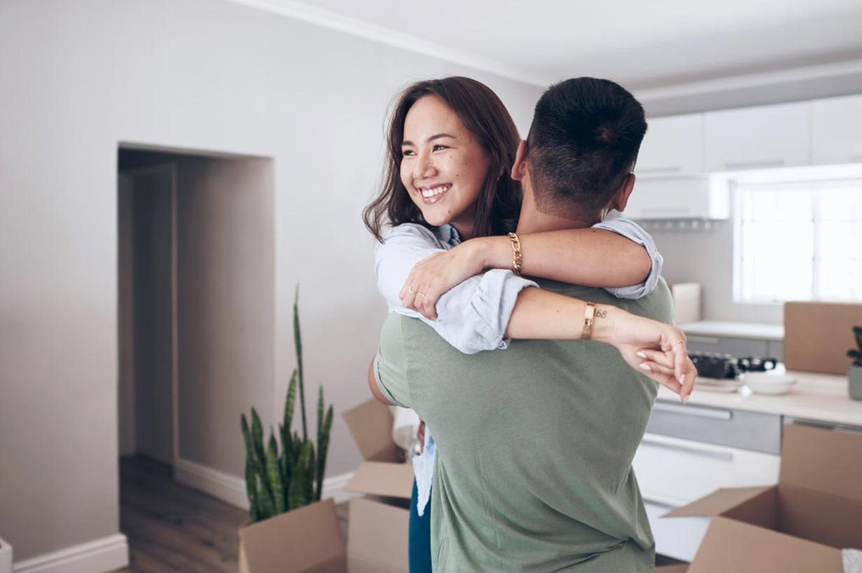 couple hugging in new home